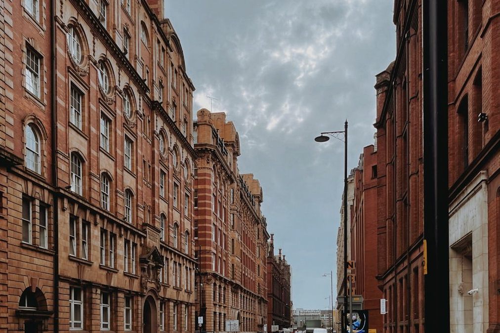 A long street of red-brick terraced buildings